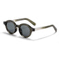 retro round-frame sunglasses featuring dark tinted lenses and dual-dot rivet accents